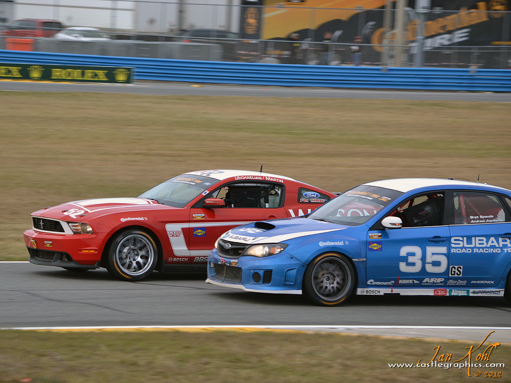 Continental Tires Race: GS battle
Two Grand Sport cars battle in the infield, the #52 Mustang on the outside of the #35 Subaru WRX-STI.
Keywords: 2012 Rolex 24