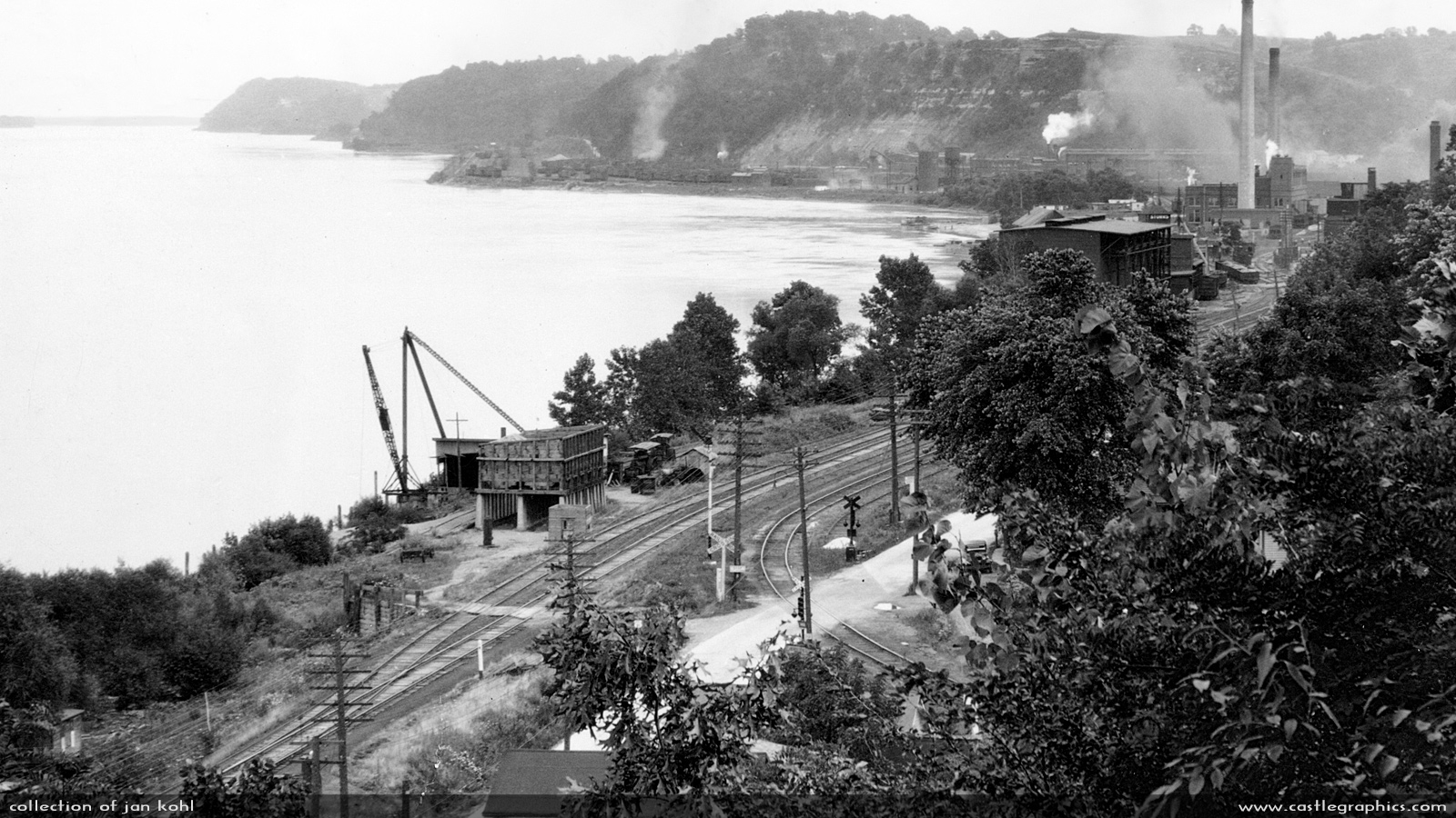 Hannibal from Riverview Park, probably early 1930s
This photo has a lot of interesting detail. The crane and gravel hopper to the left are at the location the Mark Twain bridge will be built, and you can see two steam traction engines there.  At the powerplant (right, with smokestacks) you can see some hoppers and in front of them are some gondolas and a boxcar or two.  Far distance, center, you can see the huge CB&Q yard at Hannibal, under the bluff.
