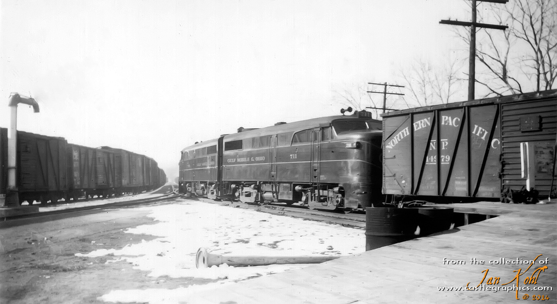 GM&O FA1s transferring freight cars
A pair of GM&O Alcos transfer some cars either to or from the CB&Q on the transfer track.  From Bill Hirt: NP box car - door replaced on this car with Youngstown Door.  XM. 40' Wood Sheathed Box w/6' Door Opening. Wood Sliding Door. Built 1931. IH 8' 9". Series #14500-14999. Photo in NP Color Guide on p37.
