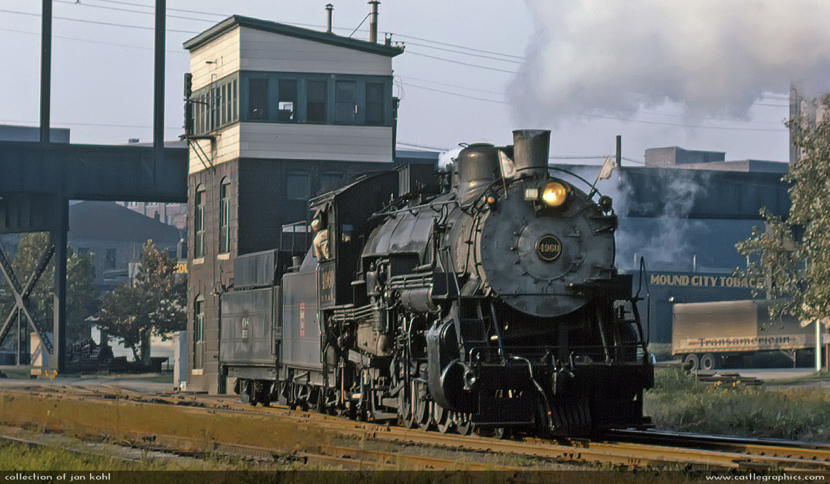 CB&Q #4960 in St Louis
August 1963 in North St. Louis when the CB&Q engine # 4960 backed from the Q Yards down to Carr St. yard to pick up a special passenger train.  In this great view, the Terminal Railroad of St. Louis' N. Market Street tower rises up behind the steamer and above is the elevated right-of-way of the Illinois Terminal RR.
